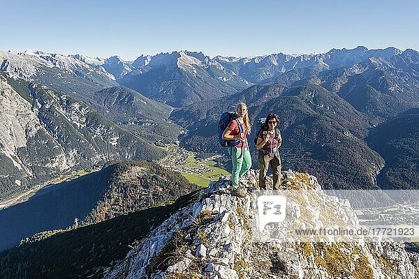 Two female hikers on a summit  mountain landscape near the Große Arnspitze  near Scharnitz  Bavaria  Germany  Europe
