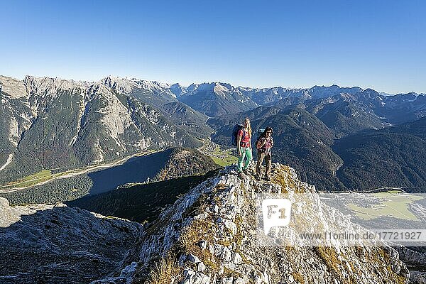 Two female hikers on a summit  mountain landscape near the Große Arnspitze  near Scharnitz  Bavaria  Germany  Europe