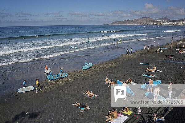 People swimming  surfing  sunbathing and eating on Las Canteras beach in Las Palmas  Gran Canaria  Canary Islands  Spain  Atlantic  Europe