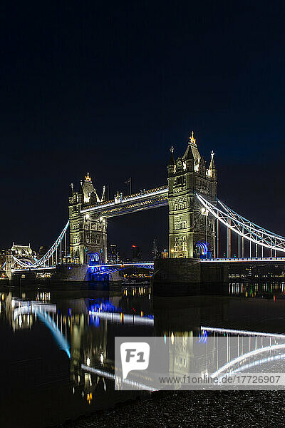 Tower Bridge at night just before sunrise  reflecting in a still River Thames  London  England  United Kingdom  Europe