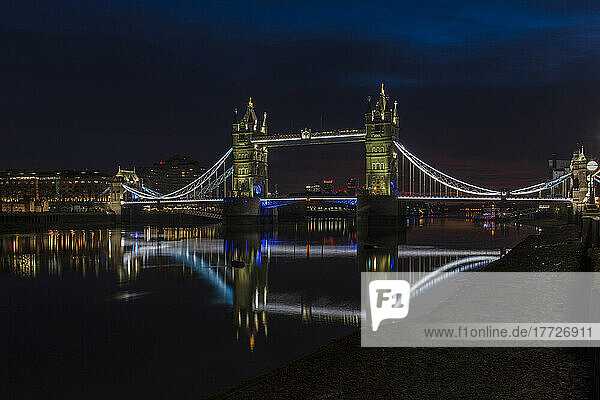 Tower Bridge at night just before sunrise  reflecting in a still River Thames  London  England  United Kingdom  Europe