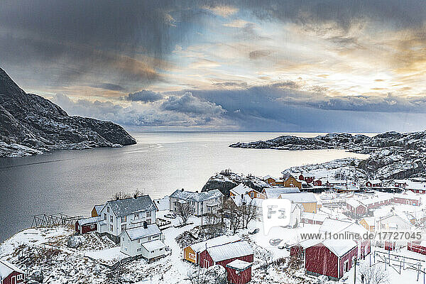 Aerial view of traditional wood houses covered with snow in winter  Nusfjord  Nordland county  Lofoten Islands  Norway  Scandinavia  Europe