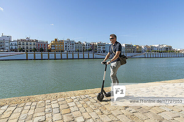 Riding an e-scooter in Seville  Andalusia  Spain  Europe