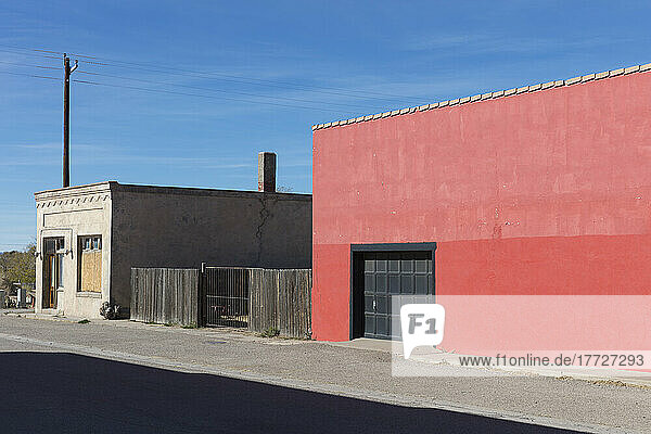 Empty buildings on Main Street  a warehouse with a red wall.