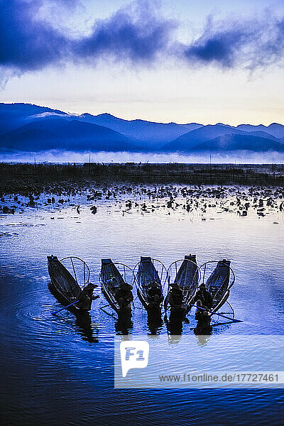 A group of fishermen on Lake Inle at dusk.