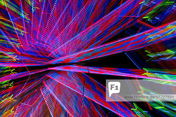 A ferris wheel at night  light patterns  red  blue and green