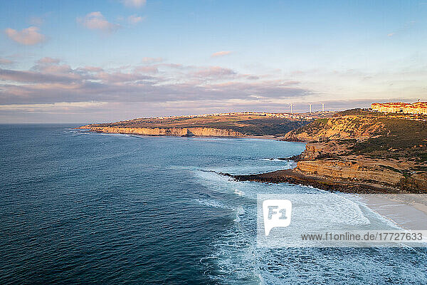 Ericeira drone aerial view on the coast of Portugal with surfers on the sea at sunset  Lisbon area  Portugal  Europe