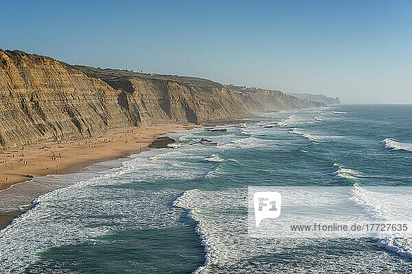 Magoito beach with surfers surfing on the sea waves  near Sintra  Portugal  Europe