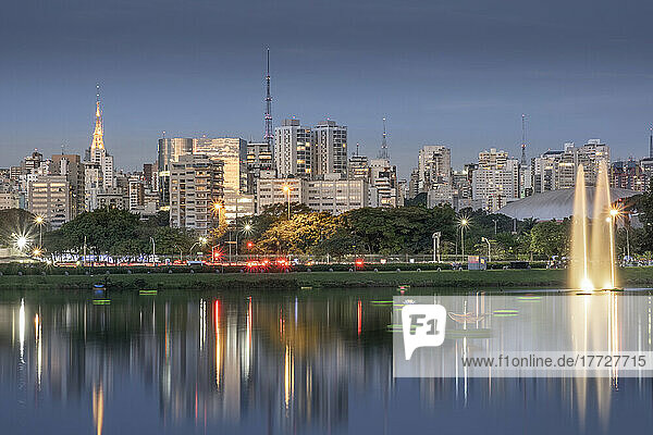 The downtown urban skyline reflected in Lago das Garcas lake at twilight  Ibirapuera Park  Sao Paulo  Brazil  South America