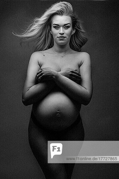 Artistic shot of a pregnant woman in a studio  United Kingdom  Europe
