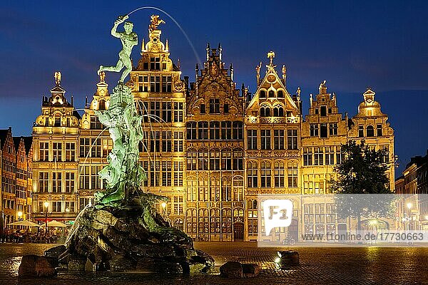 Antwerp famous Brabo statue and fountain on Grote Markt square illuminated at night and old houses Antwerp  Belgium  Europe