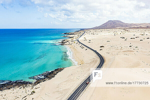 Aerial view of road crossing the desert overlooking the crystal sea  Corralejo Natural Park  Fuerteventura  Canary Islands  Spain  Atlantic  Europe