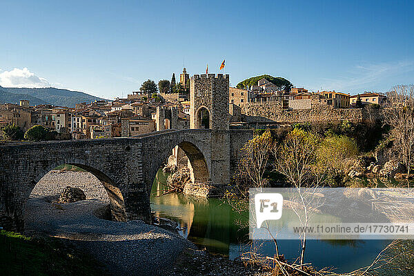 Besalu historic medieval city with Catalonia flags on the stone bridge tower crossing El Fluvia river  Besalu  Catalonia  Spain  Europe