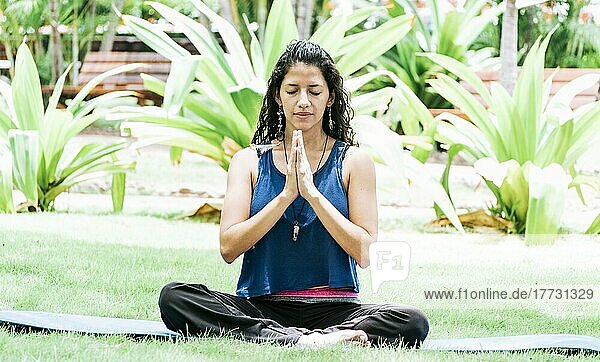 Ein Mädchen sitzt und macht Meditation Yoga im Freien  Frau macht Yoga im Freien  eine junge Frau macht Yoga mit geschlossenen Augen