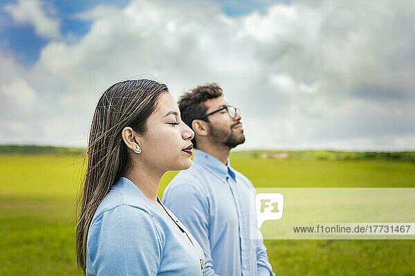 Two people breathing fresh air in the field  Young couple breathing fresh air in the field  Concept of Young couple breathing fresh air with positive attitude