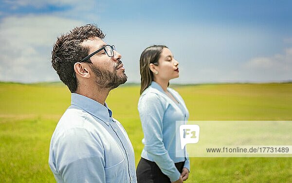 Concept of Young couple breathing fresh air with positive attitude  Two people breathing fresh air in the field  Young couple breathing fresh air in the field
