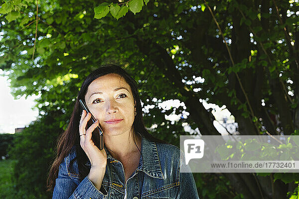 Woman talking on smart phone in park
