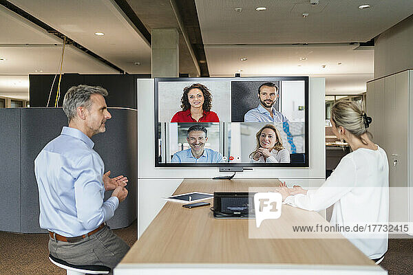 Businessman and businesswoman having a video conference in office