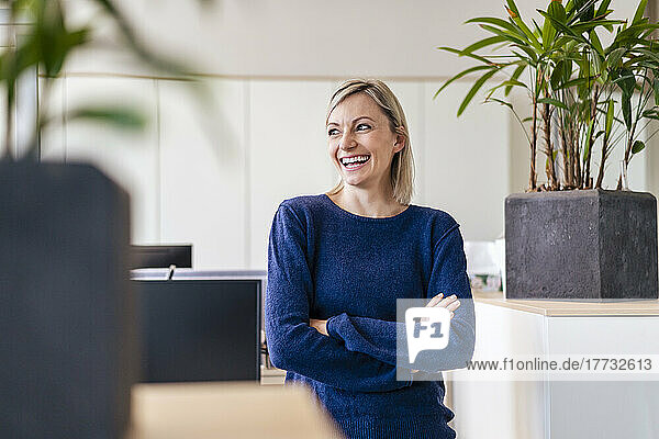 Happy businesswoman laughing in office