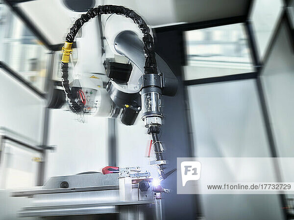 Blurred motion of robotic arm in industry