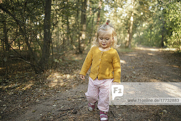 Cute girl walking in forest