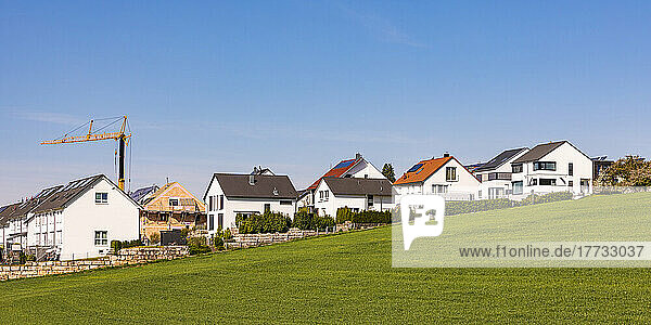 Germany  Baden-Wurttemberg  Waiblingen  Modern houses in new development area with industrial crane in background