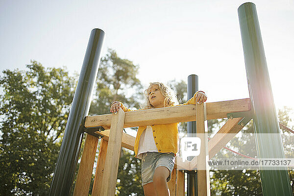 Girl playing at playground on sunny day