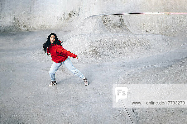 Woman dancing at skateboard park