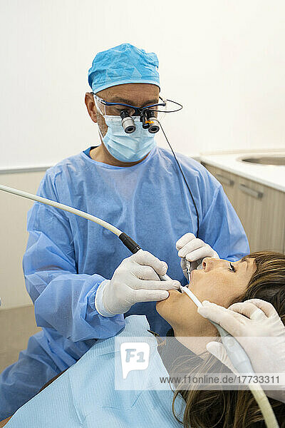 Dentists analyzing patient at clinic