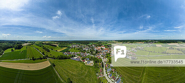 Germany  Bavaria  Kammeltal  Helicopter panorama of rural town surrounded by green fields in summer