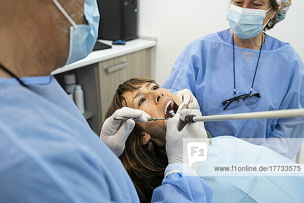 Dentists examining patient at clinic