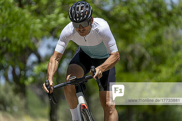 Determined athlete cycling on sunny day