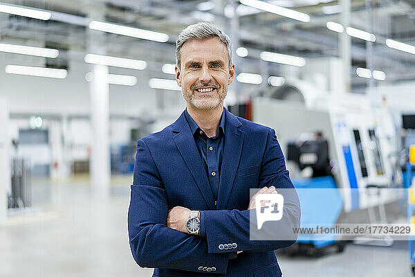Portrait of confident mature businessman in factory