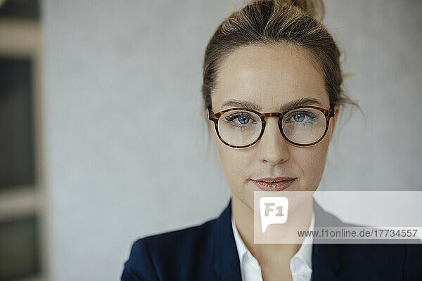 Confident businesswoman wearing eyeglasses in office