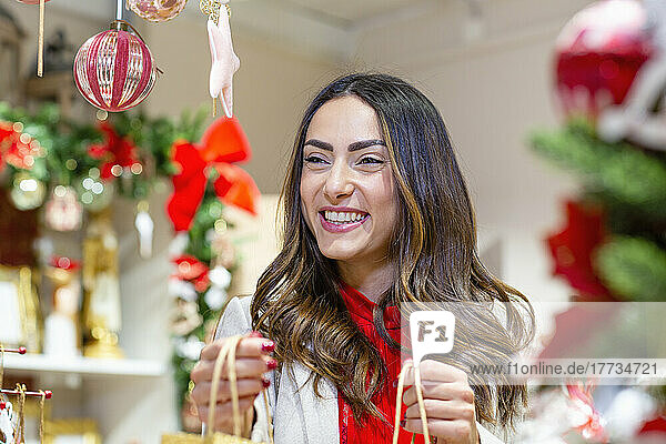 Happy beautiful woman in Christmas shop