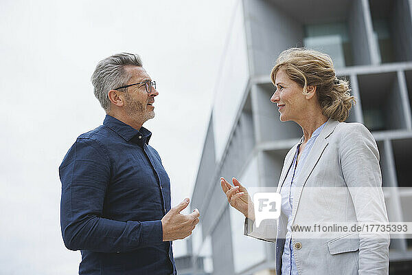 Businessman discussing with businesswoman