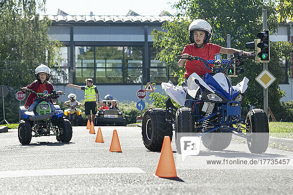 Boy riding quadbike on traffic course at traffic education training