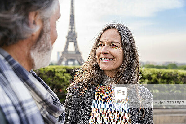 Smiling mature woman looking at man in front of Eiffel Tower  Paris  France