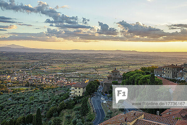 Italy  Province of Arezzo  Cortona  View of town overlooking Chiana Valley at dusk
