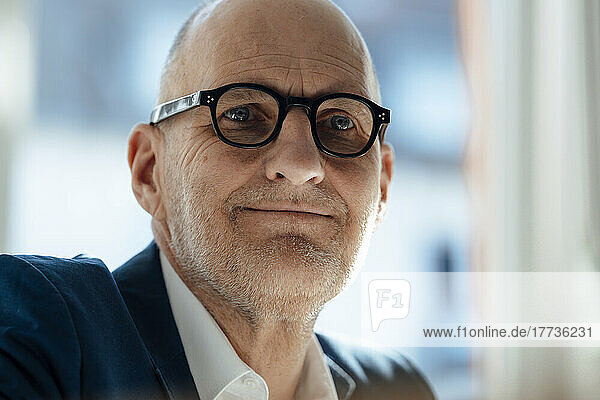 Smiling senior businessman wearing eyeglasses in office