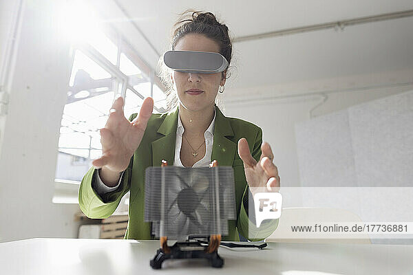 Female engineer developing new technology using virtual reality simulator