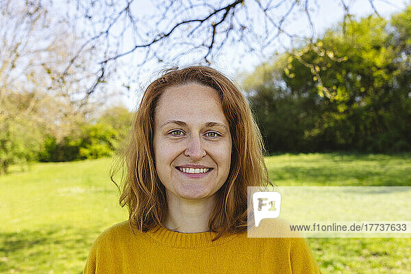Glückliche Frau mit braunen Haaren im Park