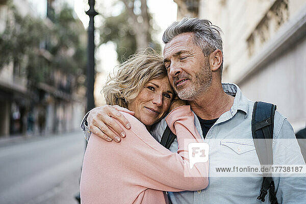 Smiling woman leaning on man's shoulder