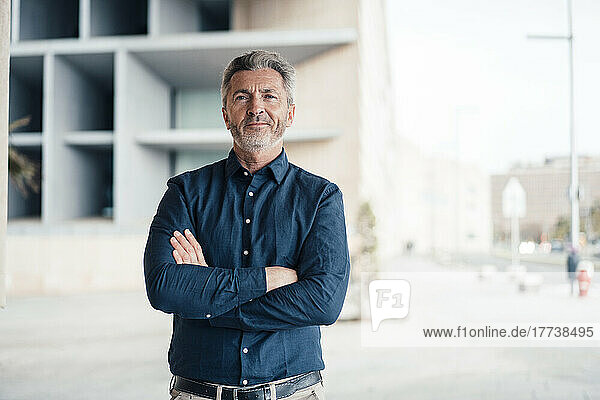 Mature businessman standing with arms crossed