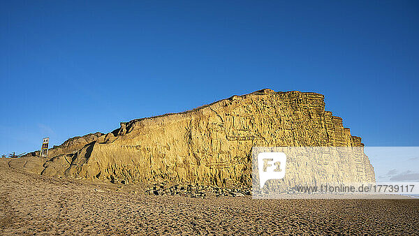UK  England  West Bay  Sandy beach and sandstone cliff along Jurassic Coast