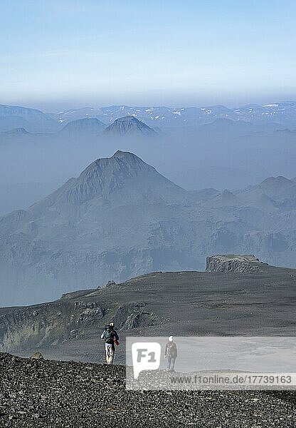 Two hikers on trail through volcanic landscape  Fimmvörðuháls hiking trail  Þórsmörk Nature Reserve  Suðurland  Iceland  Europe
