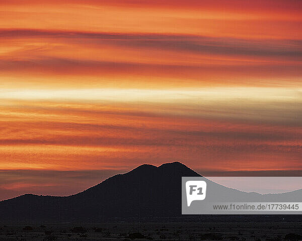 USA  New Mexico  Santa Fe  Silhouette of mountain against orange sky at sunset