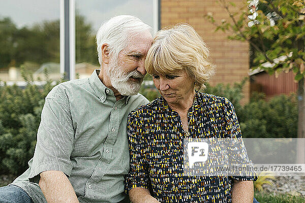 Portrait of senior couple in backyard