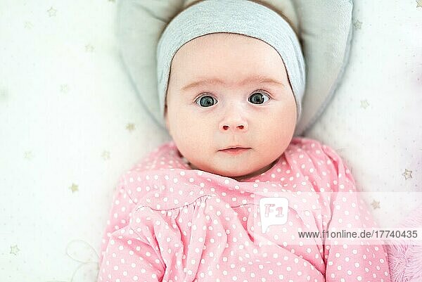 Close-up portrait of a beautiful baby on bright background. New born concept