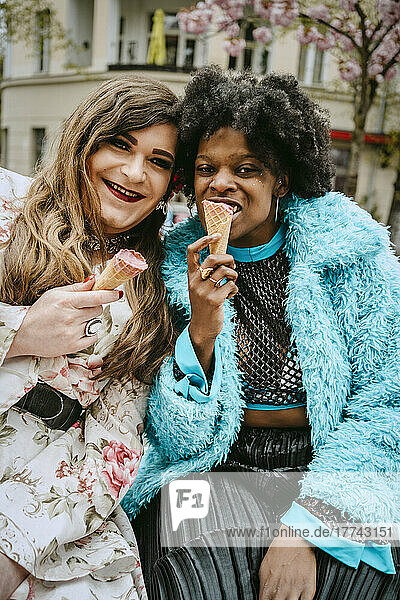 Portrait of woman and non-binary friend eating ice cream